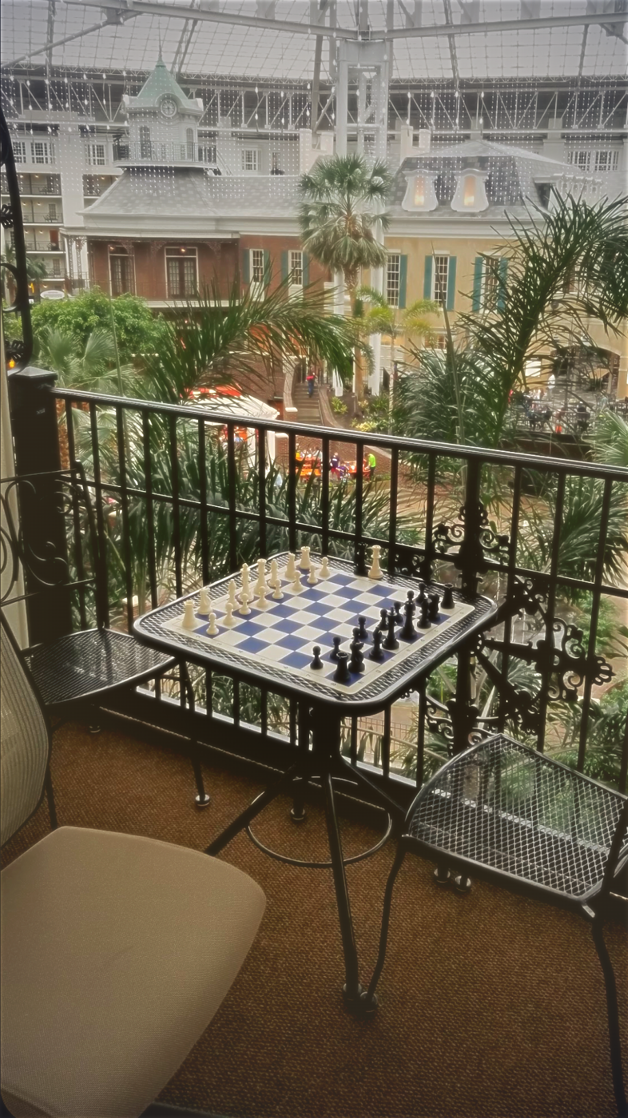 A chess board set up on a hotel balcony